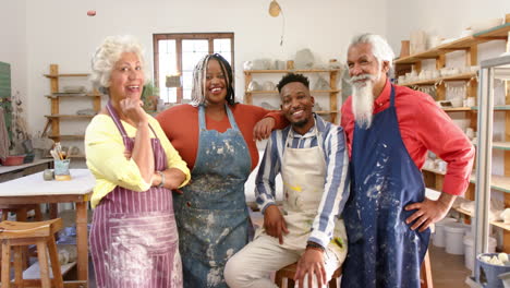 happy diverse group of potters smiling in pottery studio