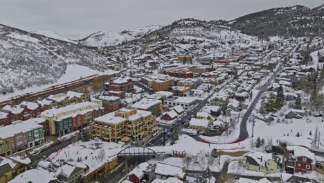 park city utah aerial v74 low drone flyover town center capturing hillside homes, downhills ski activities and winter mountain landscape covered in white snow - shot with mavic 3 cine - february 2023