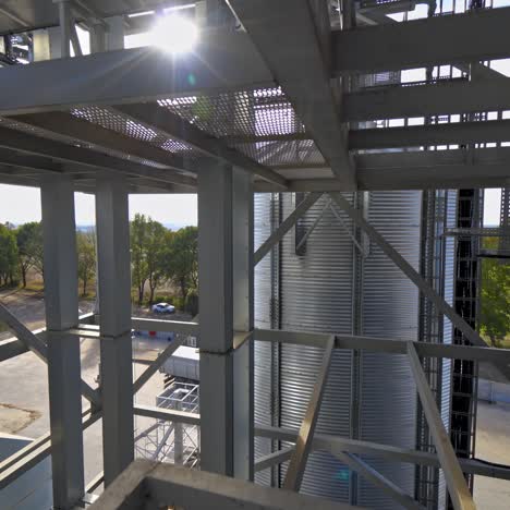 facility frame construction. industrial plant at sunlight. steel equipment of agricultural granary. exterior of a factory. close-up.