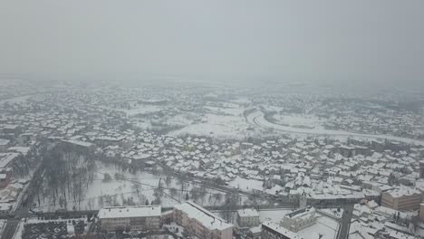 aerial view of small town covered in snow