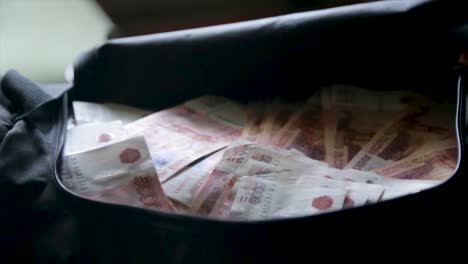 large sum of russian rubles in a black bag