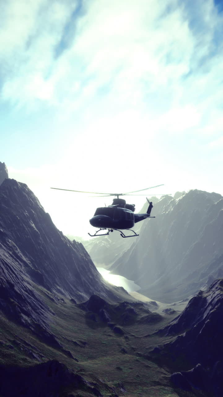 Helicopter flying over a majestic mountain range at sunrise