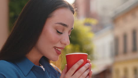 lovely woman enjoying drinking morning aroma coffee hot drink relaxing taking a break in city street