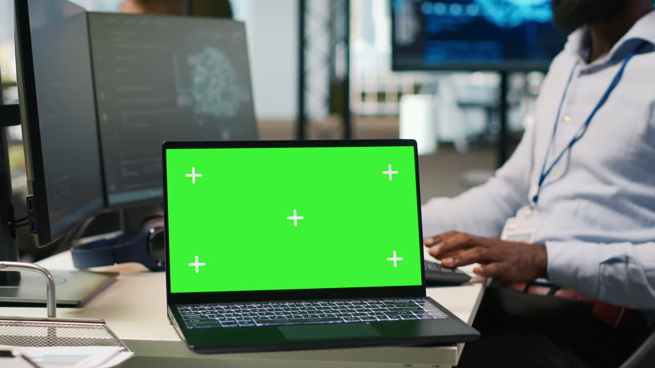 Technician Using Mockup Laptop Next To Office Coworkers Developing Applications