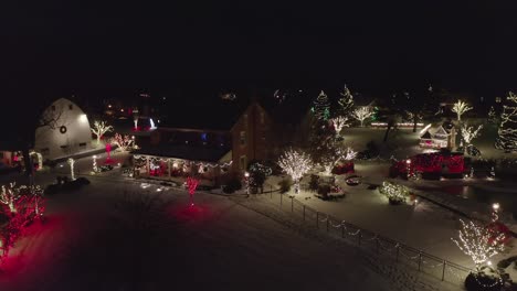 aerial of home and barn decorated for christmas