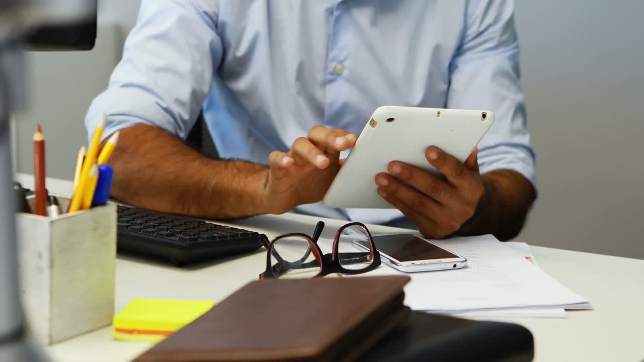 Male executive using digital tablet