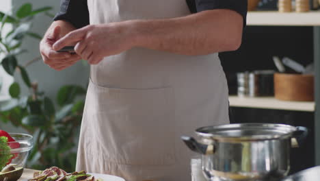 chef taking picture of food in kitchen