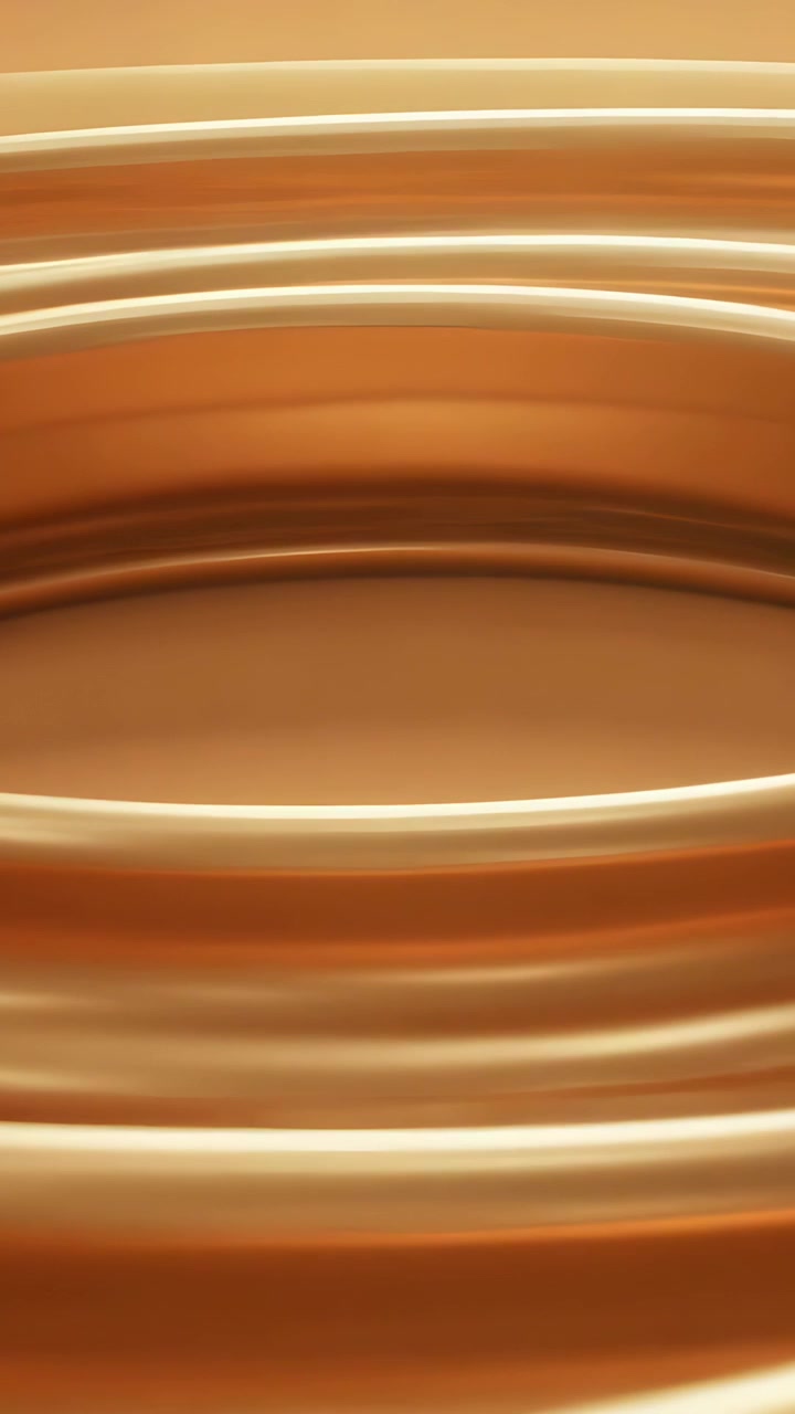 Vertical video: Flowing concentric rings forming shallow basin in studio under warm light