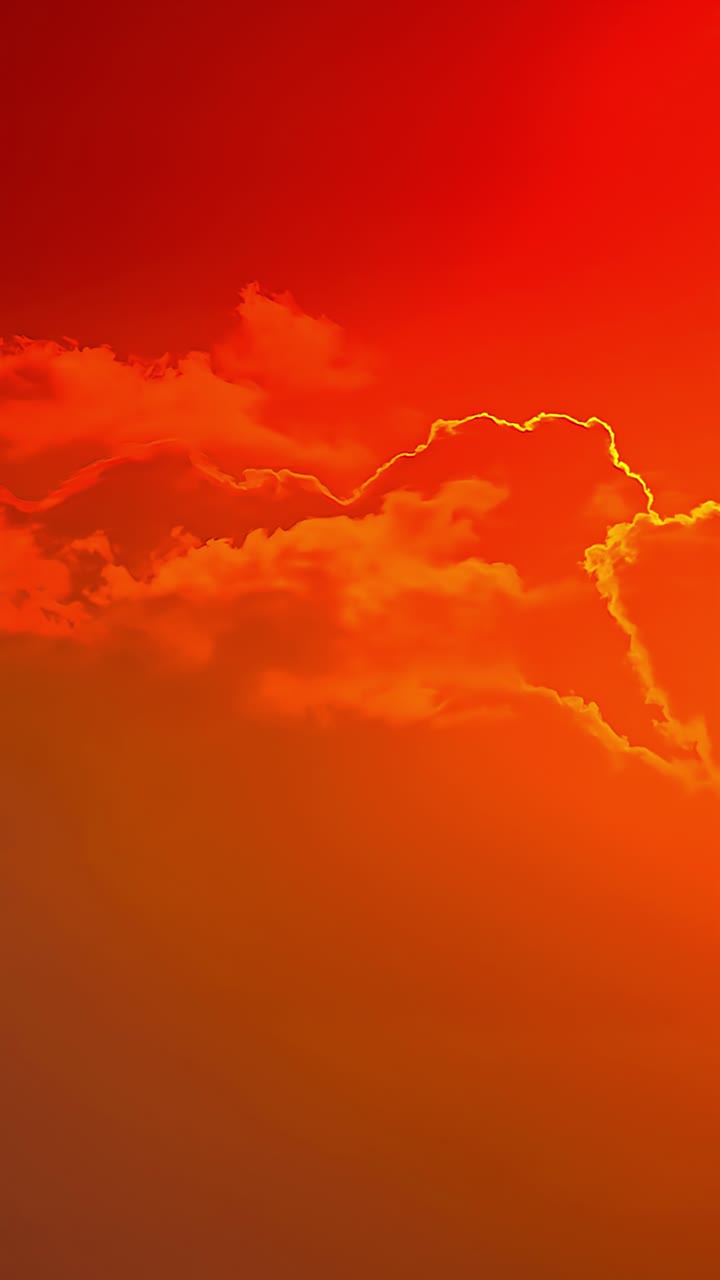 Red orange sunrise sky with soft clouds over distant landscape, tranquil morning illuminating to mesmerizing day