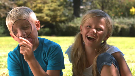 Silly-brother-having-fun-with-a-magnifying-glass-