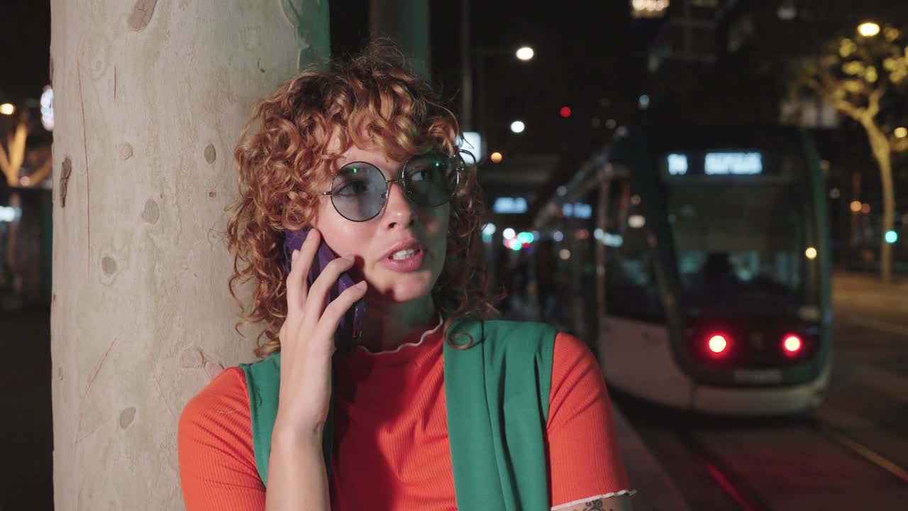 Woman talking on the phone at night