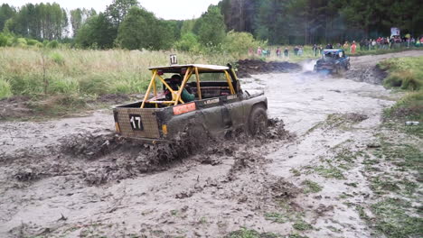 off-road vehicles racing through deep mud