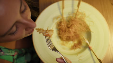 woman having sophisticated shrimp dish for dinner at the restaurant