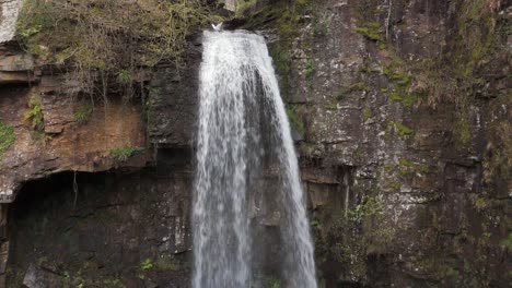 An-aerial-view-of-Melinclourt-Waterfall-on-an-overcast-day,-Neath-Port-Talbot,-South-Wales