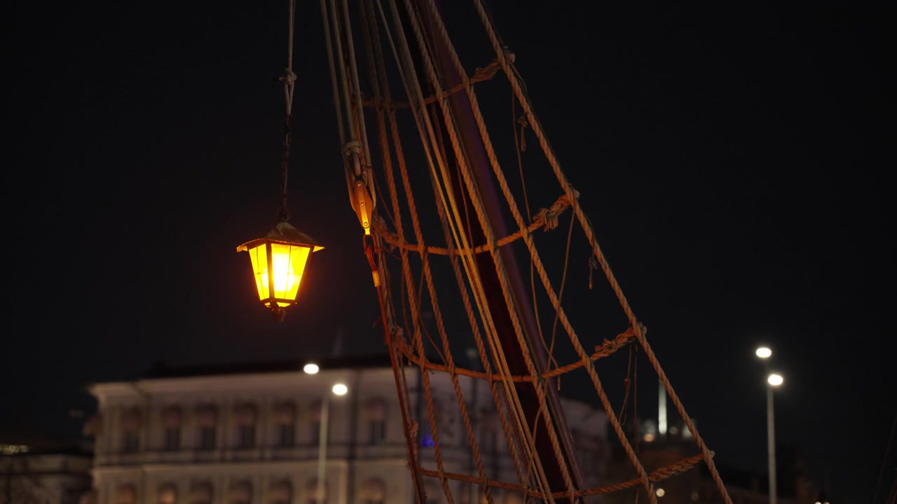Lanterna su una barca in fiamme di notte. Inquadratura statica media