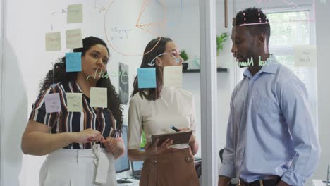 Focused-diverse-group-of-business-people-working-together,-brainstorming-in-modern-office