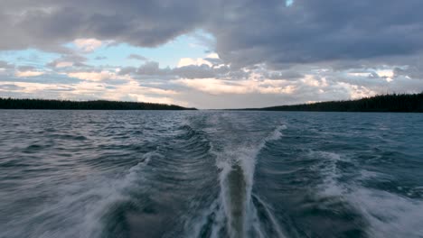 speeding boat on a lake under a splendid cloudy sky
