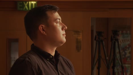 Close-up-on-ethnic-male-walking-and-coming-to-a-stop-inside-a-church-cathedral-sanctuary