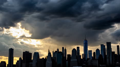 new york city skyline under dramatic storm clouds with sunset light