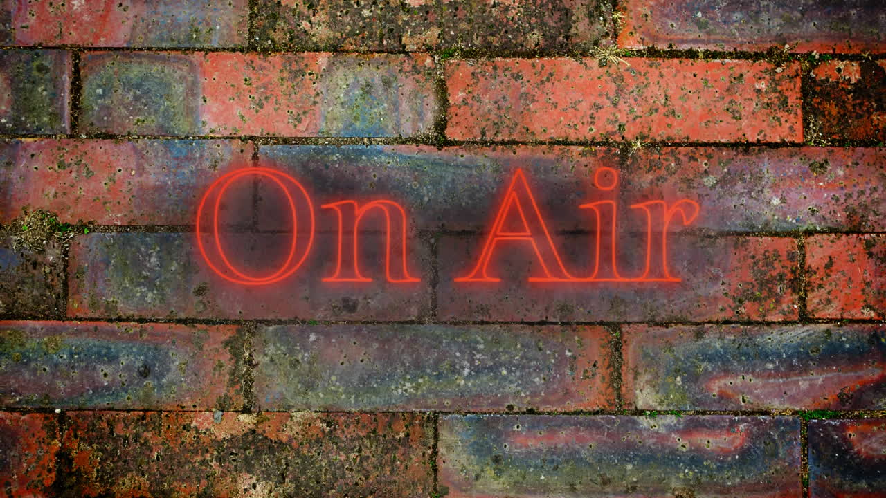 en el aire gráfico de neón rojo en la pared de ladrillo