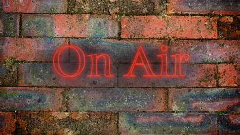 on air red neon graphic on brick wall