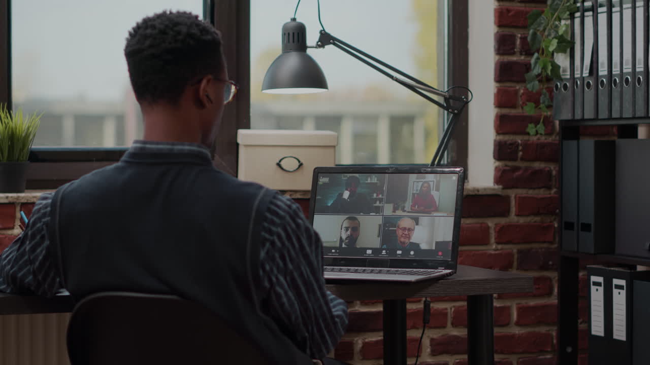 Man attending business meeting with colleagues on video call