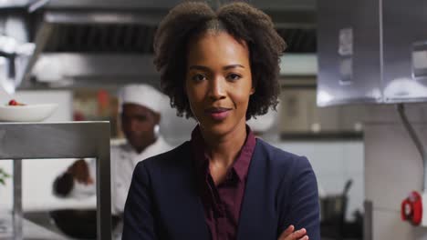 Portrait-of-african-american-female-manager-with-arms-crossed-in-restaurant-kitchen