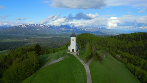 flight over the jamnik church in slovenia reveals beautiful alpine scenery