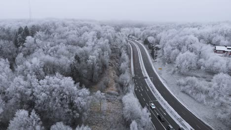 sweden landscape with road and wintry snow-covered trees, aerial establishing