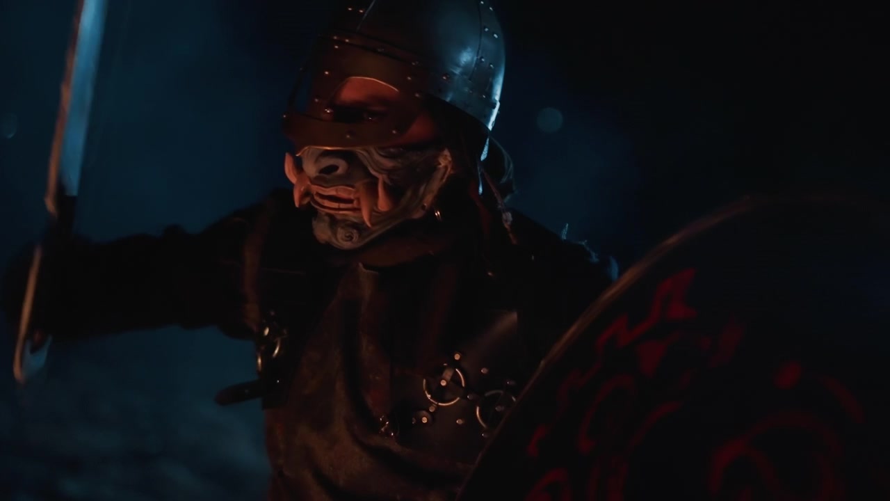 Armored figure with skull-like mask and heavy helmet lunges forward in aggressive pose, swinging blade while round decorated shield stays visible, with blurred motion, dark shadows, and cinematic
