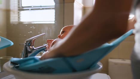 young mom applying some cream by her hand on baby 4k