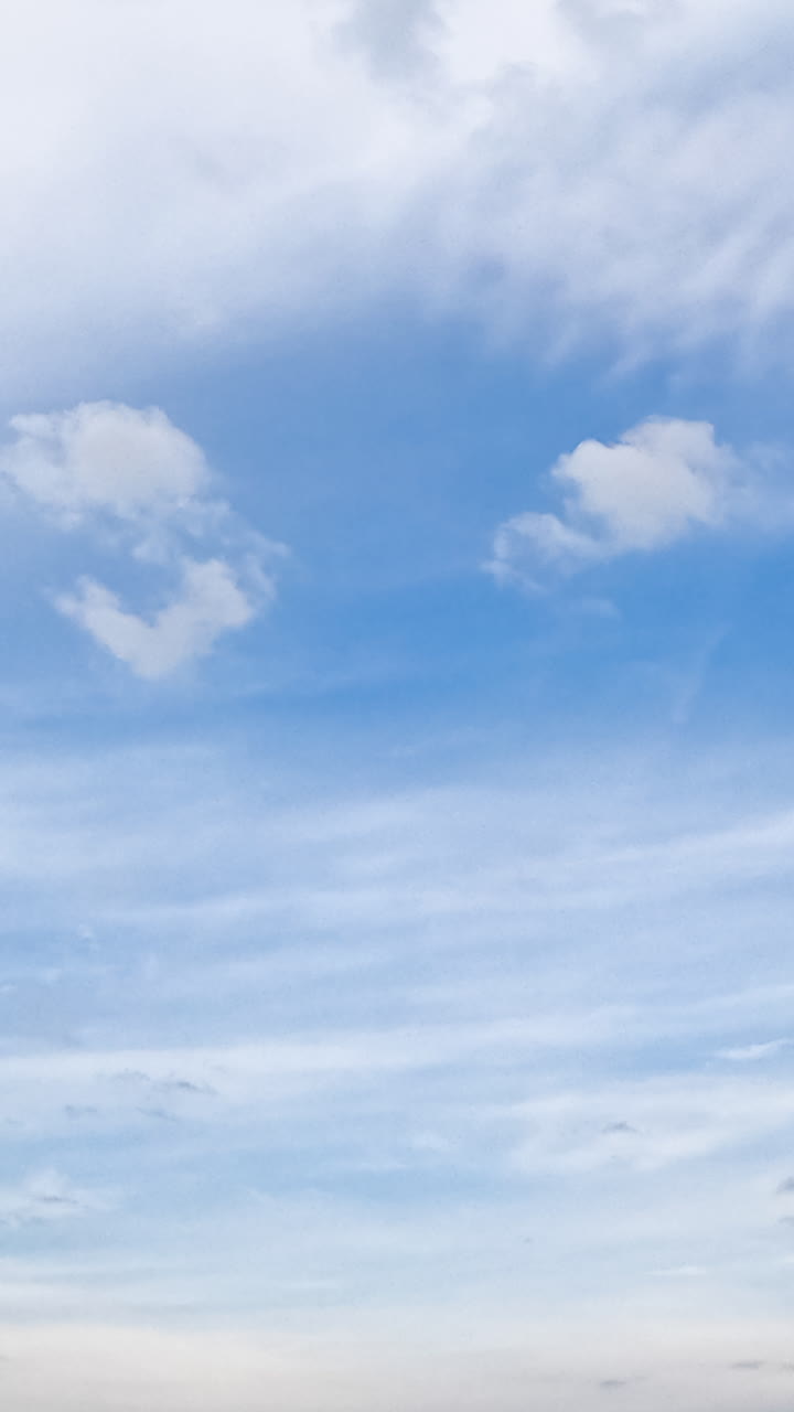 Cirrus and cumulus clouds moving in the sky. Beautiful horizon from low angle view. Timelapse. Vertical video