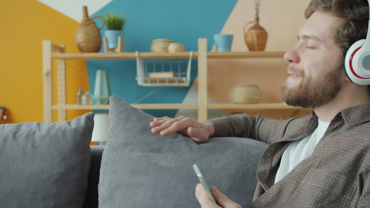 Man Listening to Music on Headphones at Home