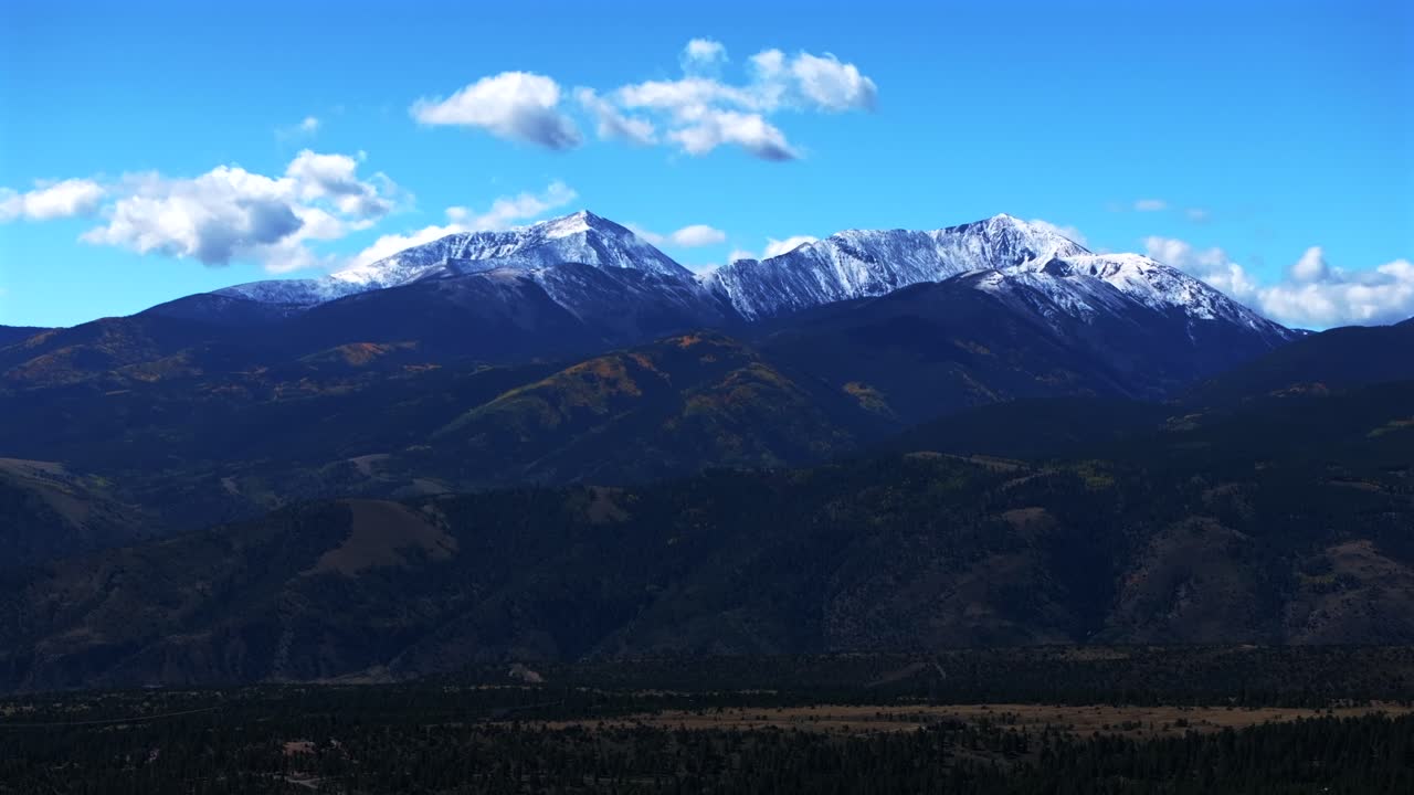 Mt Mount Shavano 14er Tabeguache Peak aerial drone Colorado trail Sawatch Range fall autumn aspen trees San Isabel National Forest snow dusting morning vibrant blue sky clouds backwards pan up motion