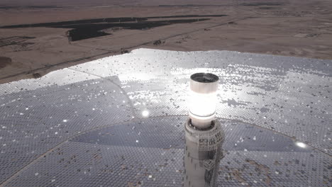 solar power tower focused sunlight for movable mirrors at the desert in a cloudless day- close up tilt down drone dolly in shot-1