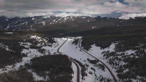 Vail-Pass-Colorado-i70-highway-cars-trucks-sky-chutes-Copper-Mountain-ski-resort-trail-runs-ten-mile-range-Ikon-snowy-winter-spring-snowy-peaks-evening-clouds-sunset-forward-reveal-motion