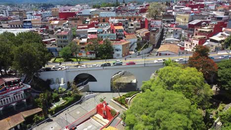 aerial drone tilt up shot over a historical bridge of xalapa, xalapa city, veracruz, mexico at daytime, colorful city in summer travel over america historic place touristic point