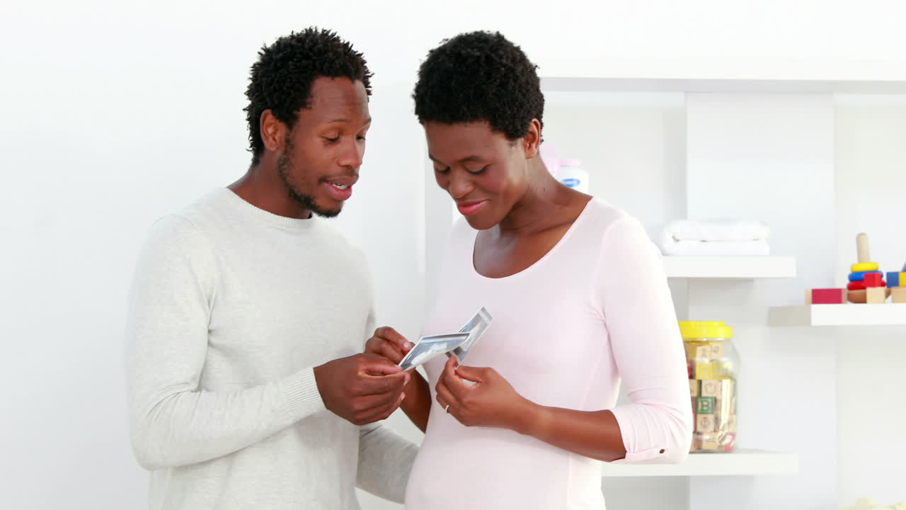 Standing couple looking at the ultrasound