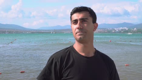 man drinking beer on a beach