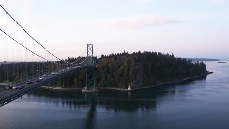 4k aerial footage of lions gate bridge in the morning looking at vancouver and stanley park moving towards park