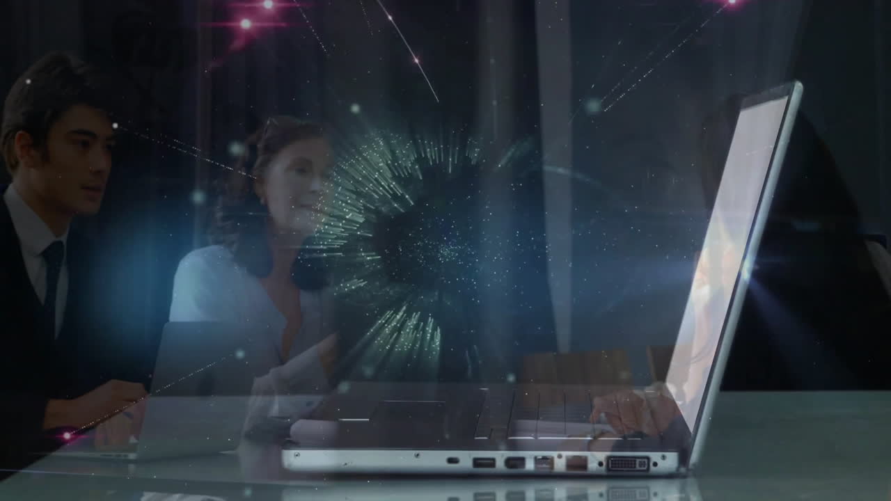 business team analyzing data around laptop, projecting holographic network graphic with pink nodes