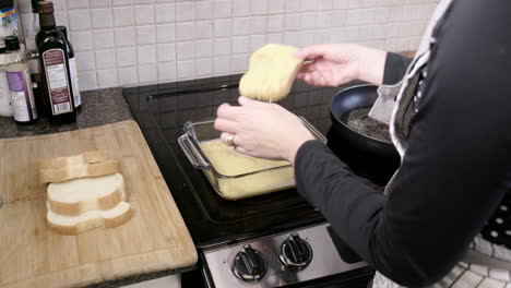 dipping bread into french toast batter for breakfast