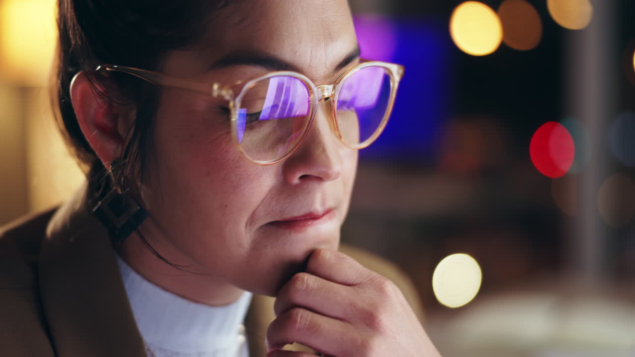 Woman wearing glasses looking thoughtful