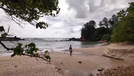 beach at flux reflux tide indian ocean sri lanka rough sea day tourist walking
