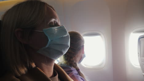 tired passengers wearing protective masks during the flight in the cabin