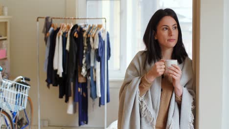 thoughtful woman having coffee at the door 4k