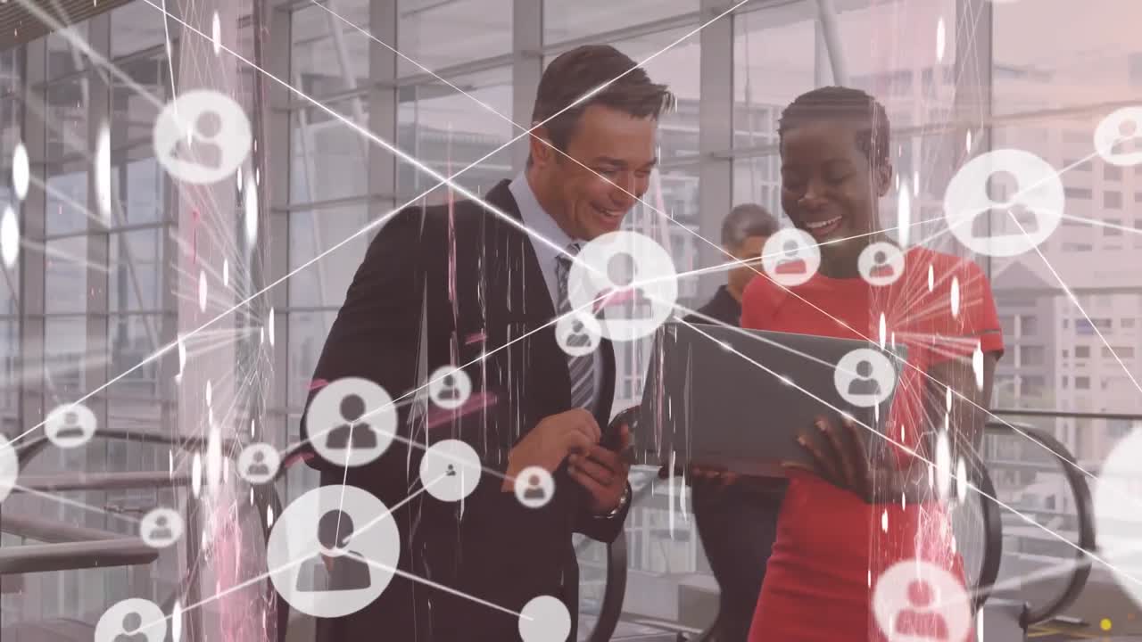 Animation of network of connections with icons over businessmen using laptop computer