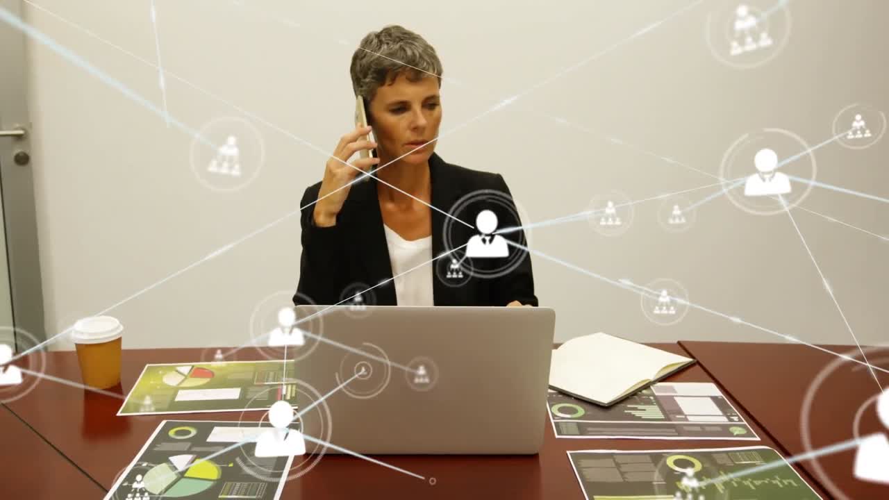 Animation of network of profile icons over caucasian businesswoman talking on smartphone at office