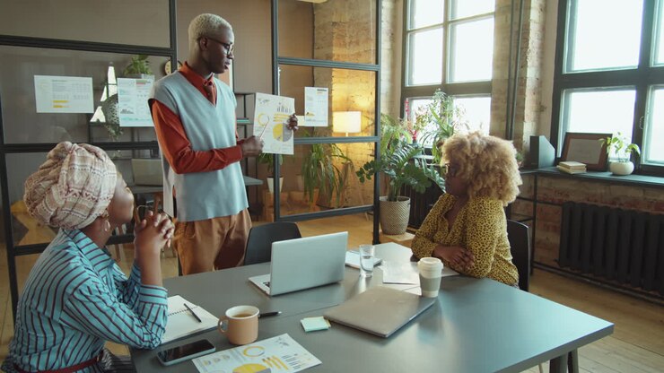 African American Businessman Giving Presentation at Office Meeting
