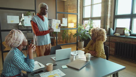 african american businessman giving presentation at office meeting